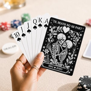May include: A hand holds a poker hand of spades: 10, Jack, Queen, King, and Ace. The Ace of Spades is next to a black card with a skeleton couple design and the text "'TIL DEATH DO US PART" and "MIKE JENNY".