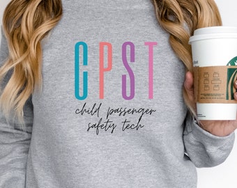 May include: Gray sweatshirt with the text "CPST child passenger safety tech" in colorful letters.