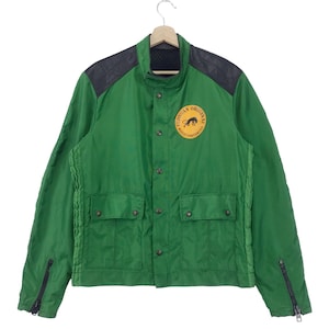 May include: A green jacket with black leather accents and a yellow patch with a black panther and the text "Furman Original World Championship".