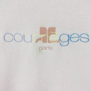 K&ouml;nnte beinhalten: Wei&szlig;er Pullover mit einem mehrfarbigen gestickten Logo, auf dem "Courr&egrave;ges Paris" steht.
