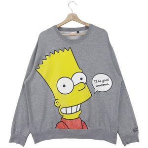 Może przedstawiać: Szara bluza z żółtym rysunkiem Bartka Simpsona z serialu Simpsonowie. Rysunek zawiera tekst "I'll be good sometimes."