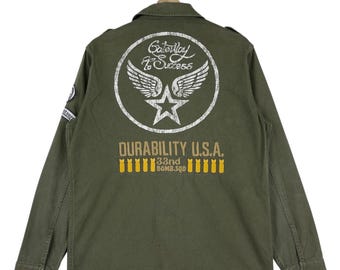 Chaqueta militar vintage Flagstaff Field con botones y parches de logotipo grandes, 33.ª bomba, talla mediana