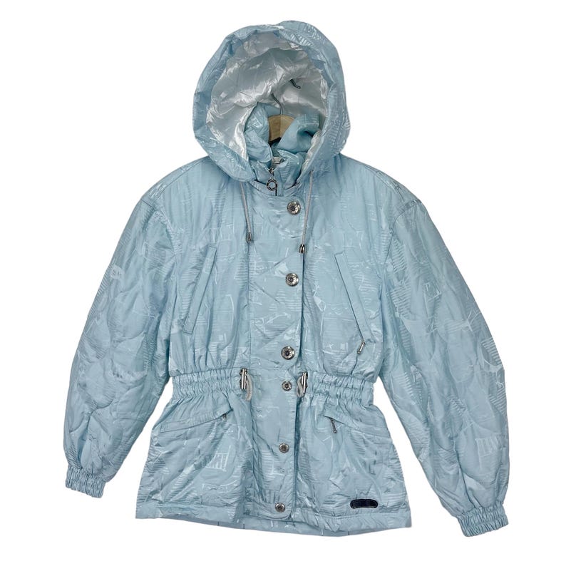 K&ouml;nnte beinhalten: Eine hellblaue Kapuzenjacke mit Kordelzug in der Taille und Knopfverschluss. Die Jacke hat ein dezentes Muster.