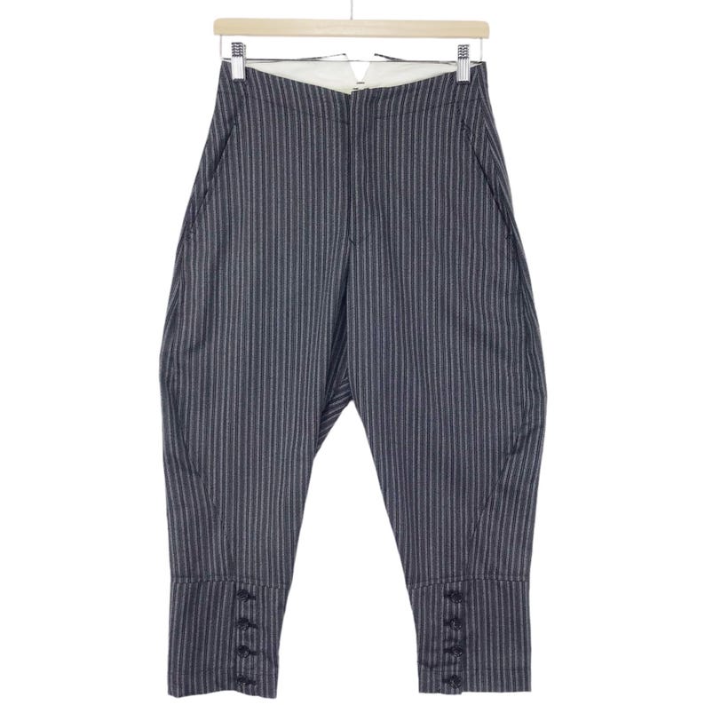 May include: Gray striped pants with a wide leg and button details at the cuffs.