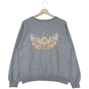 May include: Gray sweatshirt with a floral design and the word "ROXY" embroidered on the back.