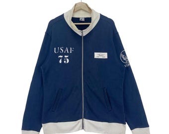 Suéter vintage Avirex de la Fuerza Aérea de EE. UU. con cremallera y logo grande. Talla mediana.
