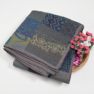 May include: A gray and blue patchwork quilt with a floral design. The quilt is made of cotton and is hand-stitched. It is a traditional Indian quilt.