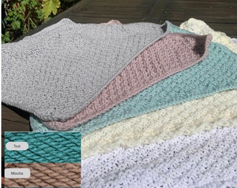 Cosy chunky hand knitted blanket with a crocheted edge.