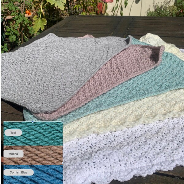 Cosy chunky hand knitted blanket with a crocheted edge.