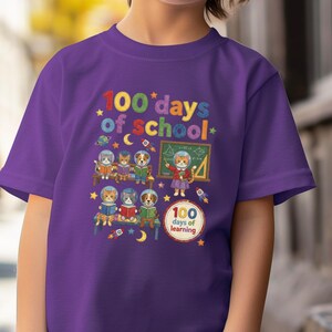 May include: A purple t-shirt featuring the text "100 days of school" in colorful letters, with illustrations of cartoon animals in a classroom setting. The shirt also has the text "100 days of learning".