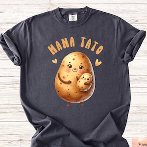 May include: A dark gray t-shirt with the text "Mama Tato" and a cartoon image of a potato holding a smaller potato. The potato has a smiling face and hearts around it.