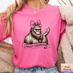 Funny Sassy Sasquatch T-Shirt, Cute Bigfoot with Bow Tee, Fun Sasquatch Graphic Coquette Tee, Unique Bigfoot Design, Gift for Women