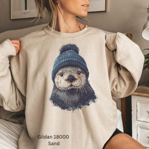Cute Otter Sweatshirt, Winter Animal Graphic, Cozy Crewneck, Fun Otter Lover Gift, Unique Otter Art Pullover, Plush Warm Sweater