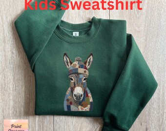 May include: Forest green kids' sweatshirt featuring an embroidered donkey wearing a patchwork hat and scarf. The text "Kids Sweatshirt" is in red at the top. The sweatshirt is made of a soft material.