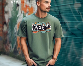 May include: A green t-shirt with a graphic print of a mountain range and the word "ICELAND" in a retro style.