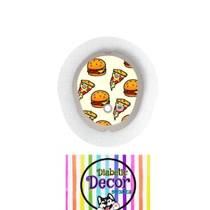 May include: A round, white medical device cover with a colorful pattern of cartoon pizza slices and hamburgers. The text "Diabetic Decor by Danica" is on a colorful striped background.