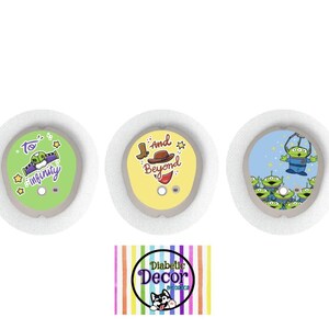 May include: Three round medical device covers with cartoon designs. One is green with the text "To infinity", another is yellow with a cowboy hat and the text "and Beyond", and the last is blue with green aliens.
