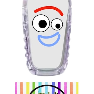 May include: A white, clear plastic medical device with a cartoon face on it. The face has red eyebrows, large black eyes, a blue smile, and a white background. The device is labeled "Diabetic Decor by Danica" on a rainbow striped background.