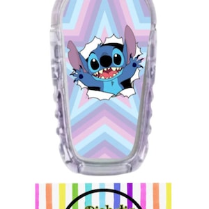 May include: A blue and purple geometric patterned sticker with a cartoon blue alien character peeking out of a hole in the pattern. The sticker is designed to fit a medical device. The text "Diabetic Decor by Danica" is on a white background with rainbow stripes.