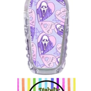 May include: A purple and pink patterned medical device skin cover with a repeating pattern of a ghost with a knife and the text "Call Me" in a heart shape. The background is a light purple with a glitter effect. The cover is for a medical device, such as a continuous glucose monitor.