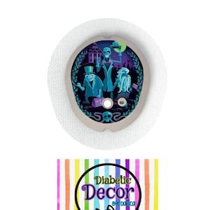 May include: A round medical device with a spooky Halloween design featuring cartoon ghosts and a haunted house. The device is surrounded by a light gray border and is set against a white background. The text "Diabetic Decor" is also visible.