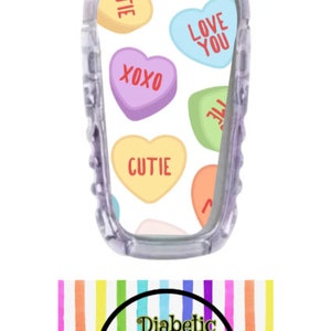 May include: Clear phone case with a design of colorful candy hearts with phrases like "Cutie" and "Love You". The case is over a background with the text "Diabetic Decor" and a husky dog.