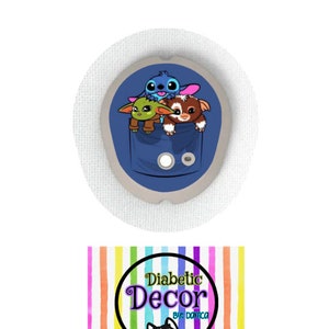 May include: A blue, green, and brown cartoon character sticker for a diabetic pump or continuous glucose monitor. The sticker features Stitch, Baby Yoda, and Gizmo from the movie Gremlins. The sticker is designed to be placed on a medical device and is part of a collection of stickers called "Diabetic Decor by Danica".