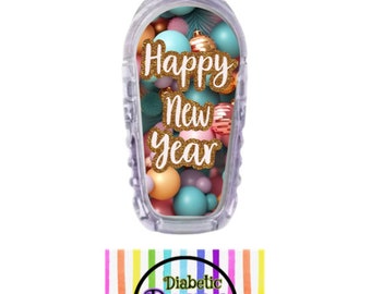 May include: A clear plastic medical device cover with a colorful design of ornaments and the text "Happy New Year" in gold glitter. The design is for a diabetic device.