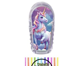 May include: A clear plastic insulin pump cover with a colorful unicorn design. The unicorn is pink, purple, and blue with a gold horn and a rainbow mane. The background is a light blue sky with white clouds. The text "Diabetic Decor by: Danica" is printed on a rainbow striped background.