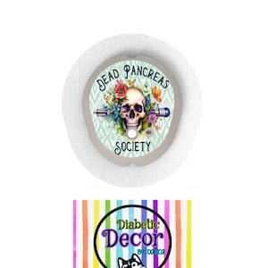 May include: A round, white medical patch with a colourful design featuring a skull with flowers and the text "Dead Pancreas Society". The patch is on a white background with a rainbow striped pattern and the text "Diabetic Decor by Danica".