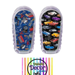 May include: Two clear plastic insulin pump covers with colorful designs. One cover features a blue background with a variety of car parts and tools. The other cover features a black background with a variety of colorful cars. Both covers have the text "Diabetic Decor by Danica" on them.