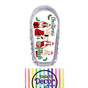May include: A white medical device cover with a Christmas-themed design featuring a group of women in Santa hats and the text "Christmas is so fetch". The cover is made by Diabetic Decor by Danica.
