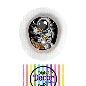 May include: A round, white diabetic patch with a colorful design of an astronaut eating pizza in space. The text "Diabetic Decor by Domica" is on a rainbow striped background.