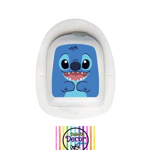 May include: A white medical device featuring a blue cartoon character face. The device is set within a white, fluffy surround. Below, a logo reads "Diabetic Decor by Dolca" against a backdrop of colourful stripes.