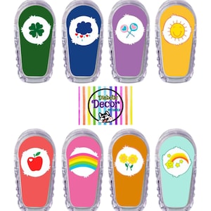 May include: A collection of eight clear plastic medical device covers with colorful designs. Each cover features a different graphic, including a four-leaf clover, a cloud with raindrops, lollipops, a smiling sun, an apple, a rainbow, sunflowers, and a star with a rainbow.