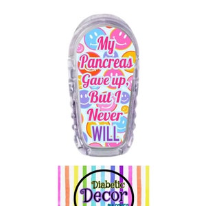 May include: A clear plastic insulin pump cover with a colorful design of smiley faces and the text "My Pancreas Gave Up, But I Never Will". The cover is designed for a diabetic pump and is a product of Diabetic Decor by Donica.