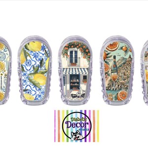 May include: Five clear decorative cases with Italian-themed designs. Designs include lemons, pasta, a shop front, a coastal scene, and a collage with the text "Ciao Bella". The cases are arranged in a row.