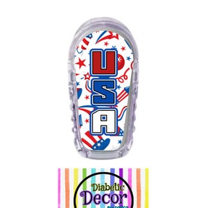 May include: A clear plastic insulin pump cover with a white background and a red, white, and blue USA design with stars, fireworks, and other patriotic imagery.