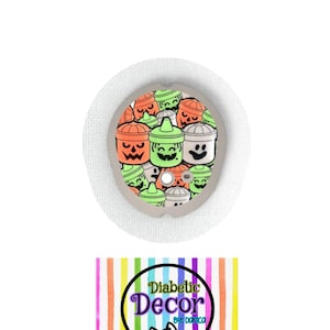 May include: A white round medical patch with a colorful design of orange, green, and gray jack-o'-lantern faces. The patch has the text "Diabetic Decor by: Damica" on a rainbow striped background.