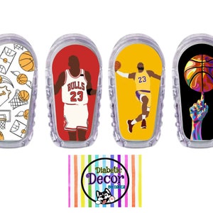 May include: Four different designs of basketball-themed stickers for a continuous glucose monitor (CGM). The designs feature a basketball, a basketball player, and a basketball court. The stickers are white, red, yellow, and black.