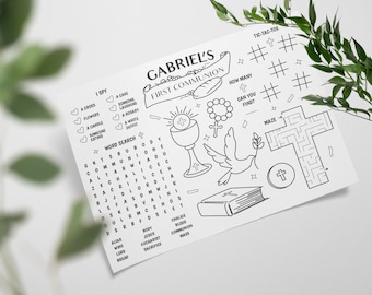 May include: A black and white printable activity sheet for a child's First Communion. The sheet includes a word search, I Spy, a maze, tic-tac-toe, and a picture of a chalice, dove, and rosary beads. The text "GABRIEL'S FIRST COMMUNION" is at the top of the sheet.