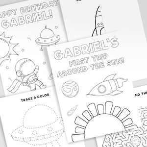May include: A black and white coloring page set with an astronaut, a rocket, a UFO, a sun, and a maze. The text on the page reads "Happy Birthday Gabriel!" and "Gabriel's First Trip Around The Sun!"