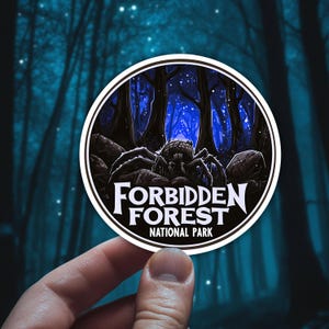 May include: A round sticker with a black spider in a dark blue forest with white stars. The sticker says "Forbidden Forest National Park".