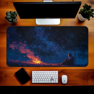 May include: A rectangular desk mat featuring a digital art scene of a knight sitting by a fire under a starry night sky. The mat is surrounded by a keyboard, mouse, and other desk accessories.