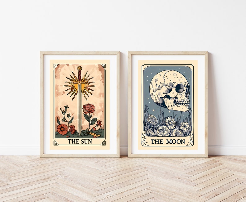 May include: Two framed tarot card prints, one depicting The Sun with a sword and flowers, the other depicting The Moon with a skull and flowers.