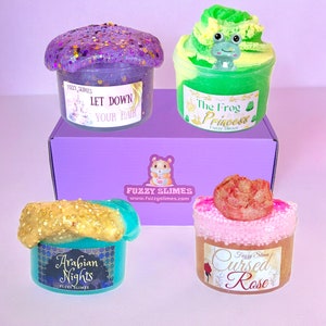 May include: A set of four slime jars with different colors and themes. The jars are labeled "Let Down Your Hair", "The Frog Princess", "Arabian Nights", and "Cursed Rose".