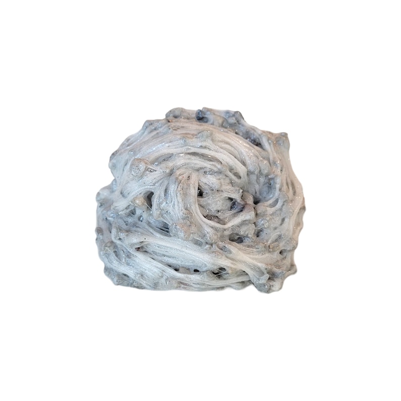 May include: A white and gray, naturally formed, fibrous mineral cluster. The mineral has a rough, textured surface and appears to be made up of many thin, intertwined strands.