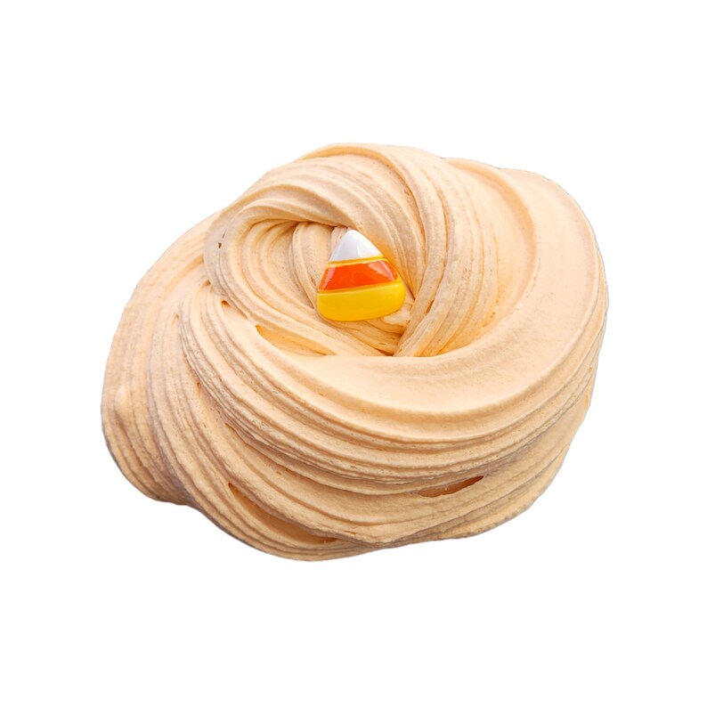 May include: A swirl of light orange slime with a candy corn charm. The slime has a smooth, textured appearance, and the candy corn charm is white, orange, and yellow. This is a fun, sensory toy for kids.