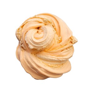 May include: A close-up shot of a swirl of light orange-colored slime, with a creamy texture. The slime is in a rounded shape, with a spiral in the center. The background is plain white.
