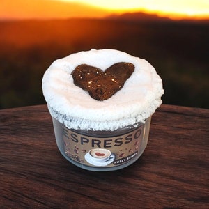 May include: A clear jar of fluffy slime with a brown heart-shaped design on top. The jar has a label that says "Espresso" and "Fuzzy Slime".